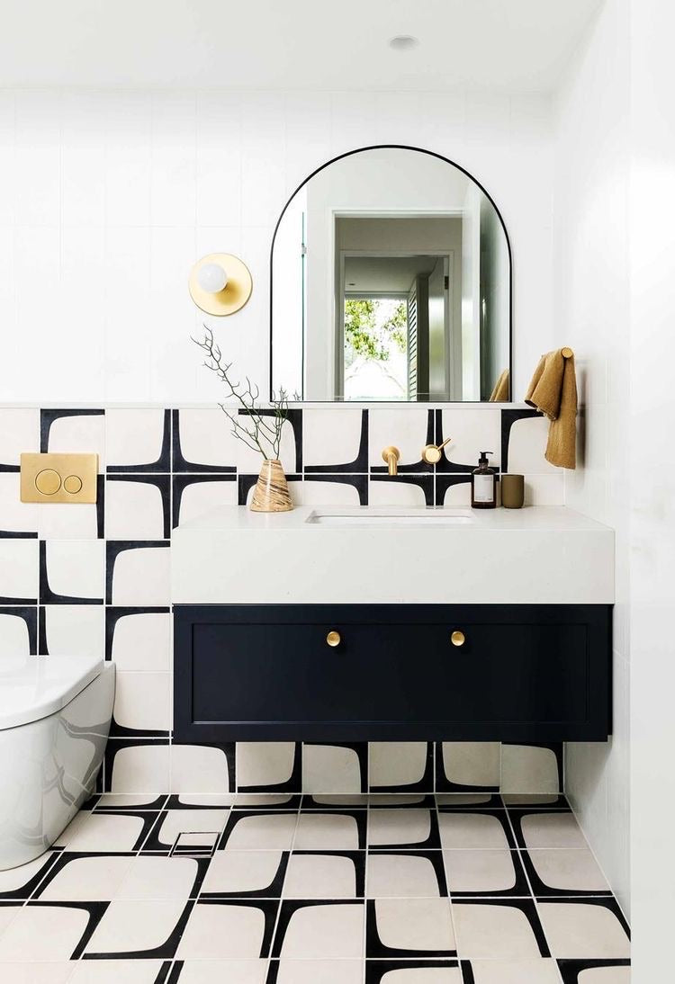 bathroom design, floating vanity, patterned tile, bold colors, gold hardware, gold finishes